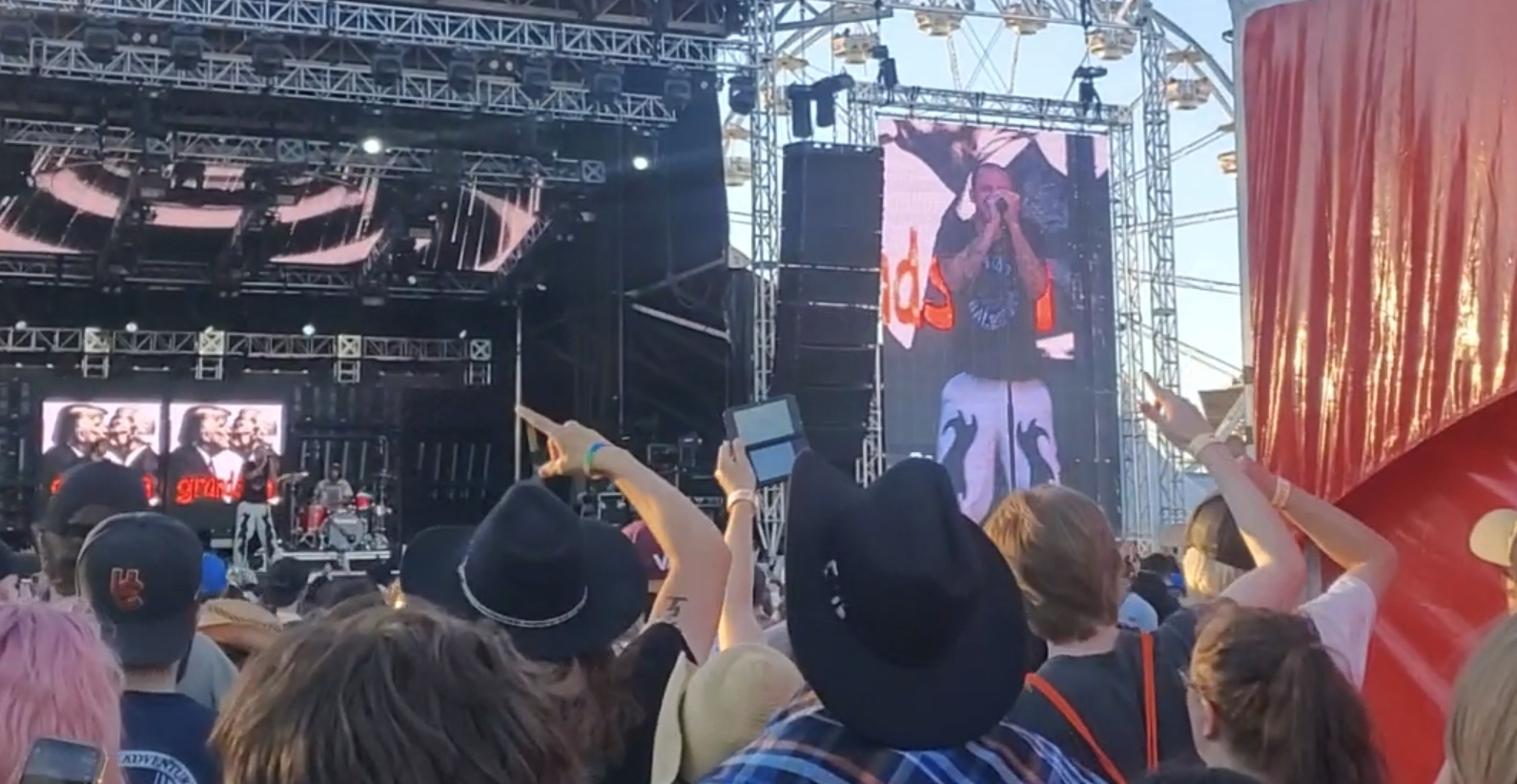 A person recording a Grandson concert using the camera on their Nintendo DS.